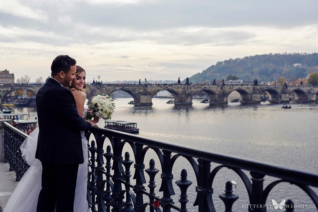 Bride and groom photos with Charles Bridge in Prague, wedding planning of destination weddings in Prague
